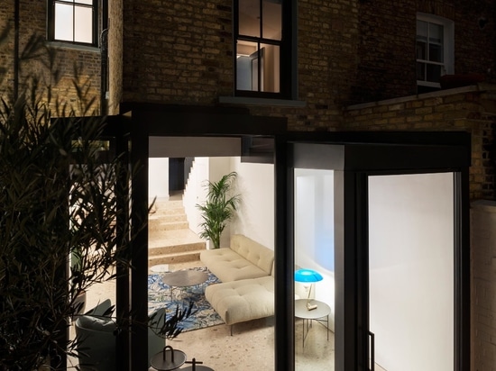 A Glass Enclosed Extension Brings New Light Into This Home