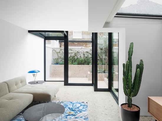 A Glass Enclosed Extension Brings New Light Into This Home