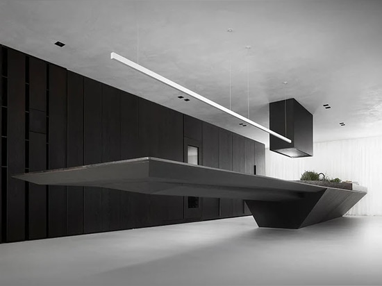 10-meter-long kitchen island. the 4-meter-long table is cantilevered from the kitchen island with no extra support