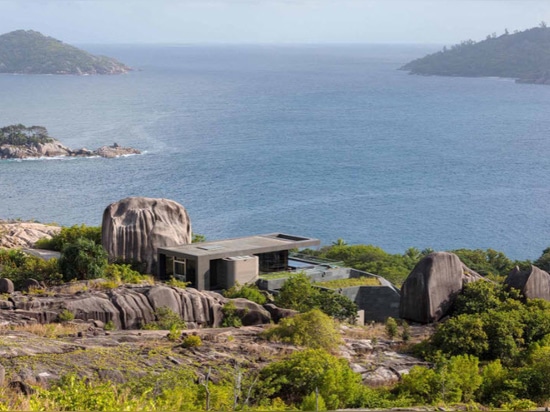 A Collection Of Modern Homes Are Built Into These Weathered Granite Cliffs