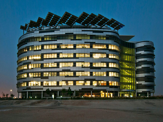 the building façade is gently curved, incorporating either horizontal or vertical shading devices