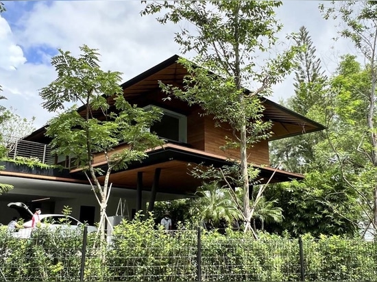 Bridges Connect To An Island In The Water-Filled Courtyard Of This Home In Singapore