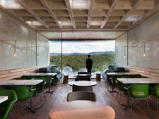 the ceiling is made with a ribbed, pre-cast slab and the outdoor veranda frames views of the dramatic scenery