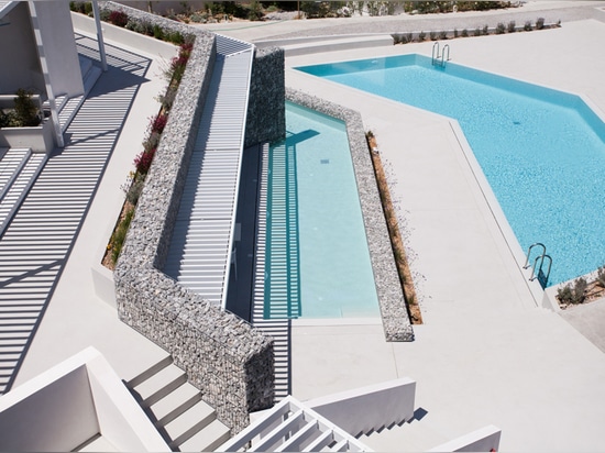 pools and outdoor spaces have been created following the uneven topography