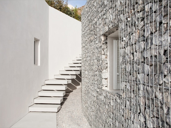 A31 architecture wraps relux hotel with gabion walls on greek island