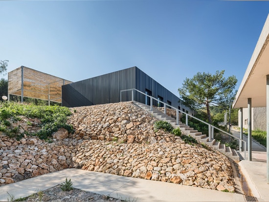 the building sits on a north-facing slope overlooking picturesque surroundings