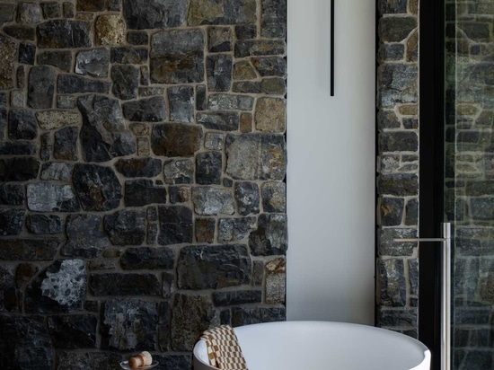 The Stone Walls Found Throughout This House Are Designed To Complement The Landscape