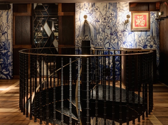 a dramatic cast iron staircase leads up to the first floor