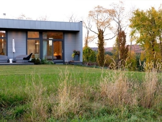 The tall window aligns with a custom roof scupper. A curtain of water falls from the scupper into a catch basin during the rain. Design by: Art Forms Architecture, Construction by: Justin DeBonis B...