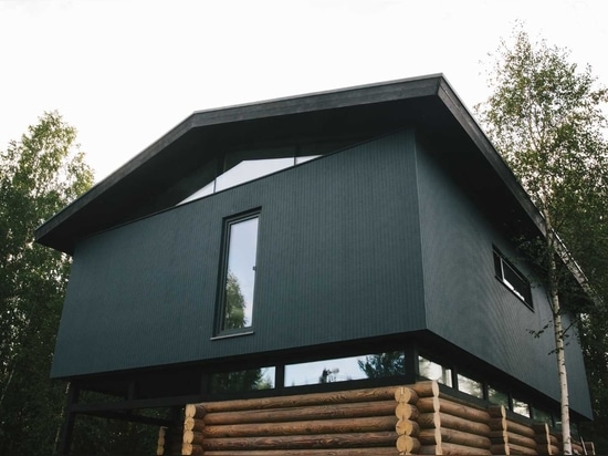 A Pile Of Logs From An Old House Were Used To Create The Bottom Half Of This New Home