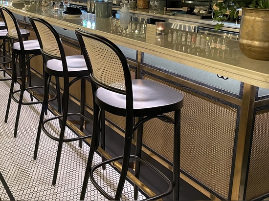 Banker Wire S-32 Brass wire mesh installed like cabinet screen at Brasserie Deck in Stockholm Sweden