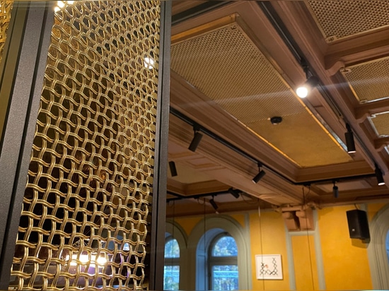 Banker Wire M22-83 Brass wire mesh installed as cabinet screen for Beirut Café in Stockholm Sweden