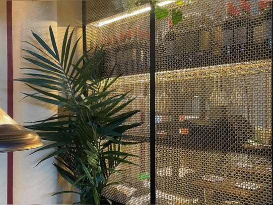 Banker Wire M22-83 Brass wire mesh installed as cabinet screen for Beirut Café in Stockholm Sweden