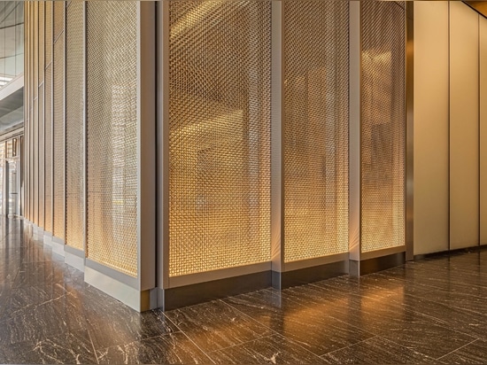 Banker Wire's M22-80 in stainless steel and brass clad against mirrors in the Frost Bank Tower lobby creates a beautiful sparkle and visual interest.