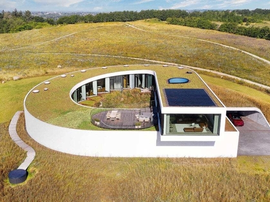 BIG completes slithering Villa Gug on the countryside hills of northern Denmark