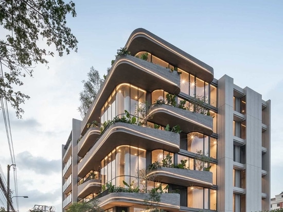 Lighting Is Used To Highlight The Rounded Balconies Of This Building