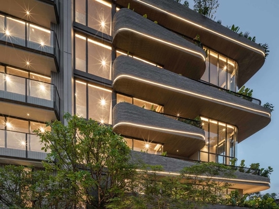 Lighting Is Used To Highlight The Rounded Balconies Of This Building