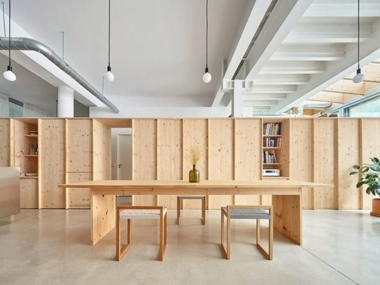 The space is split by a large wooden room divider