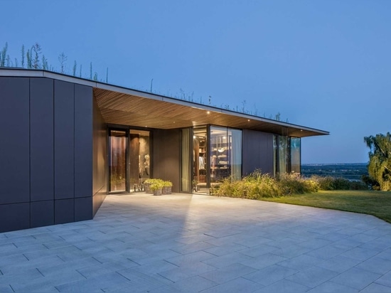 A Large Green Roof Covers This Riverside Home