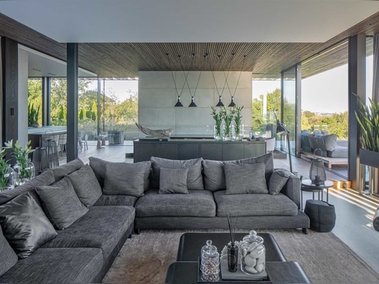 A Large Green Roof Covers This Riverside Home