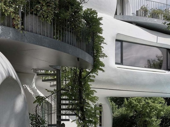 the living sculpture is accessible through an external spiral staircase