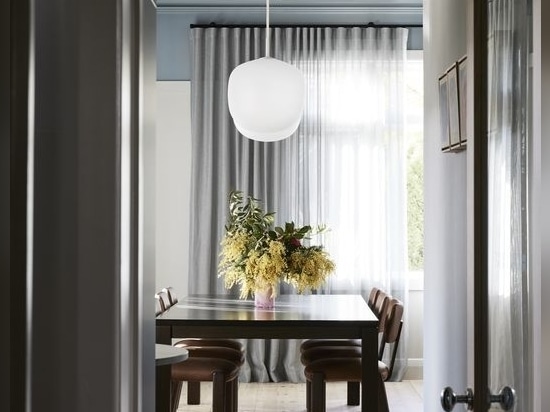 Two feature lights strategically anchor the dining table, fostering a sense of intimacy.