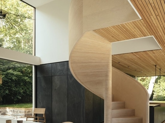 A sculptural spiral staircase sits in the dining area