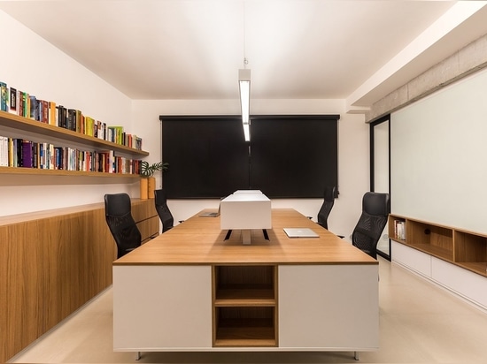 Neutral hues shape the meeting room with wood and white taking over