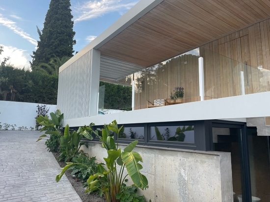 Detached single-family house with perforated metal cladding facade