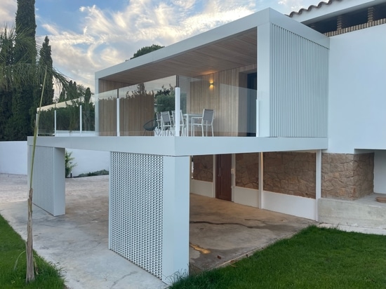 Detached single-family house with perforated metal cladding facade