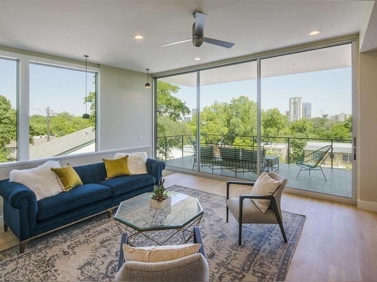 Living area on the upper level with sliding glass doors leading to the covered balcony