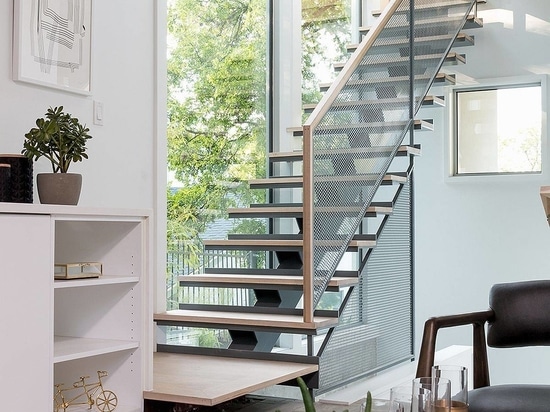 Slim and stylish modern stairway with wooden treads and metallic mesh railing