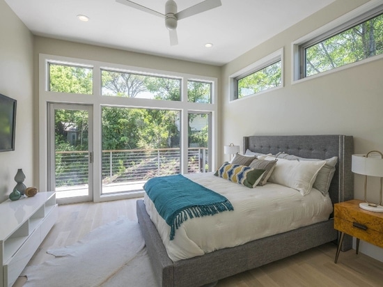 Contemporary bedroom of the home connected with the poch offers lovely green views