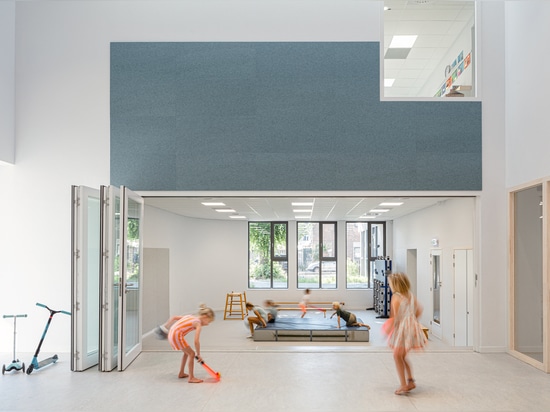 the playroom connects with the lounge through a large glass wall that can be folded away