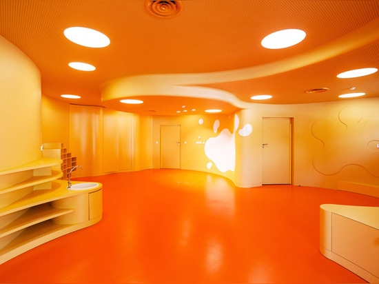 the nursery classrooms have a circular shape and an orange tone for stimuation