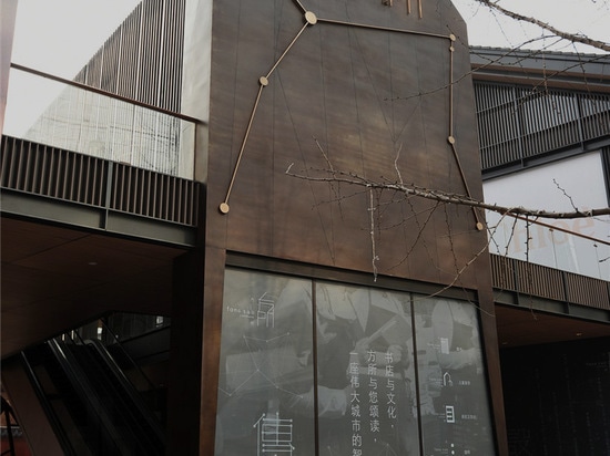 the claustrophobic entrance opens into a wide, spacious bookstore