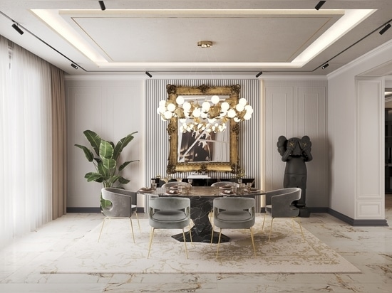 An elegant dining room where a faux-marble dining table takes center stage, bathed in the warm glow of a charming suspension lamp above. The pièce de résistance is an exclusively designed mirror th...