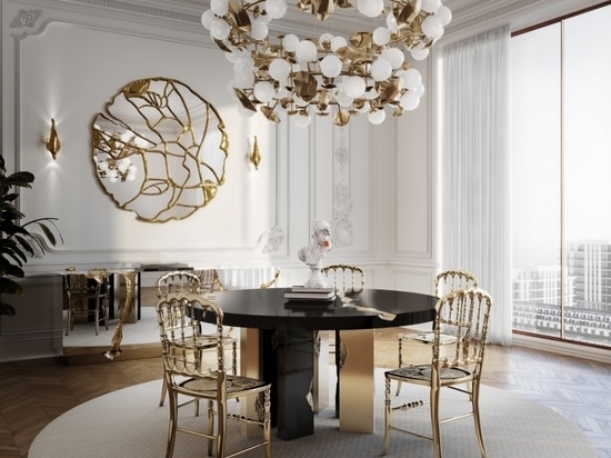 A dining room where the fusion of warmth and elegance is epitomized by an Empire round dining table adorned with wood and brass finishes. Its inviting design beckons guests to gather around in styl...