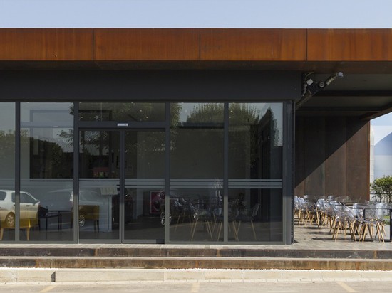 Muum’s D Cafe in Turkey is a flexible daylit space wrapped in recycled metal plates