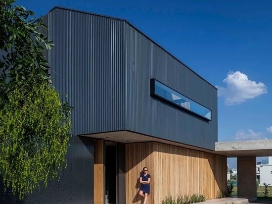 The exterior mixes metal and wooden cladding