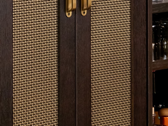 Kitchen remodel installed beautiful new walnut cabinets adorned with Banker Wire’s S-12 woven wire mesh in a plated Antique Brass finish