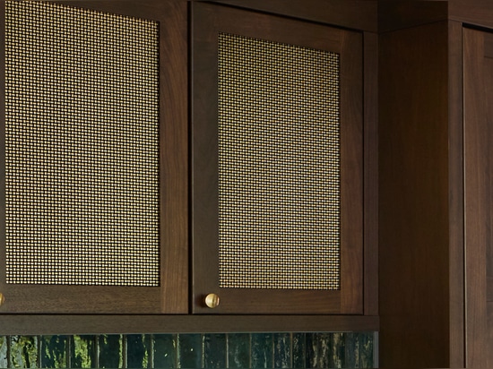 Kitchen remodel installed beautiful new walnut cabinets adorned with Banker Wire’s S-12 woven wire mesh in a plated Antique Brass finish