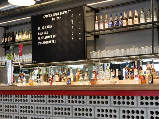 perforated grey bricks form the main bar continuing with the graphical dotted patterns seen throughout the design