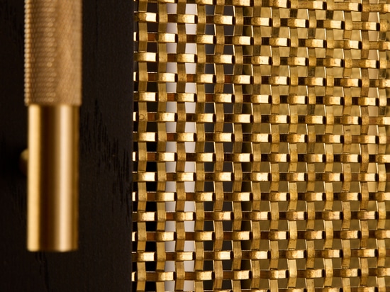 The Seaholm Cocktail Bar features Banker S-32 woven wire mesh in brass to match the cabinet's dark hardwood oak.