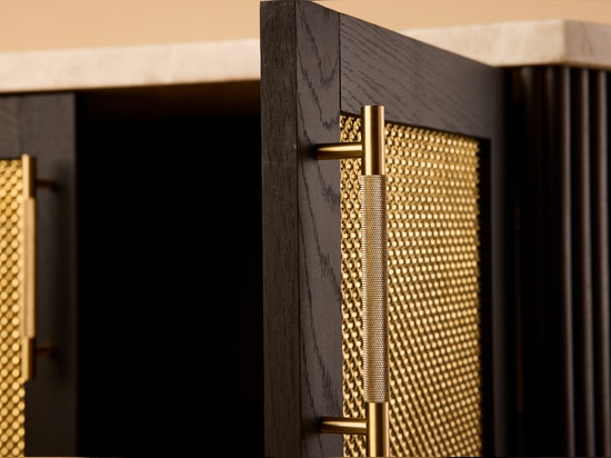 The Seaholm Cocktail Bar features Banker S-32 woven wire mesh in brass to match the cabinet's dark hardwood oak.