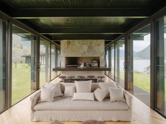 The interiors are lined with eucalyptus floors, feature stone fireplaces (1), and white-painted pine walls (2).