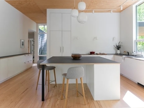 The kitchen uses simple off-the-shelf cabinets