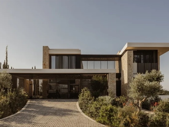 A Costa Navarino house peeks out from amidst olive groves to ocean views