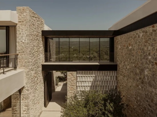 A Costa Navarino house peeks out from amidst olive groves to ocean views