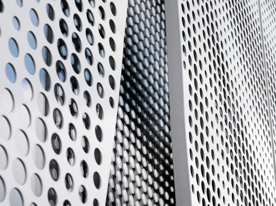 A hotel in Sweden gets a pavilion draped with perforated aluminium